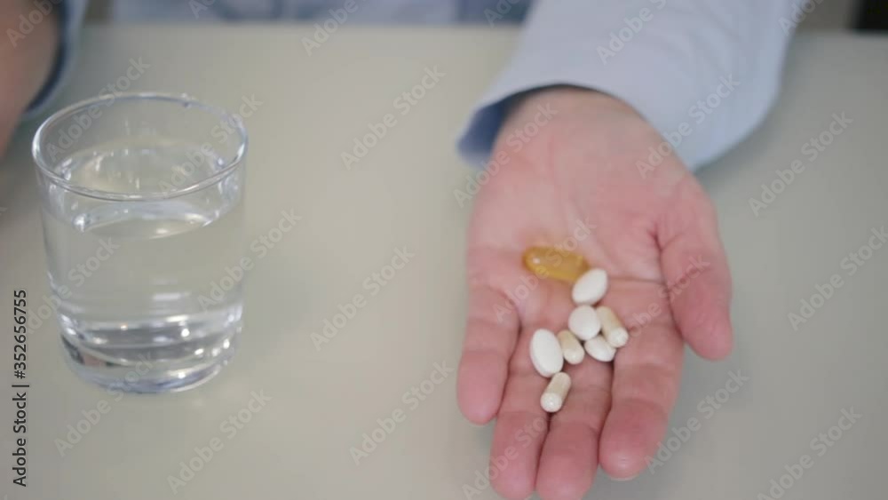 Variety pills and capsules of antibiotic treatment, painkiller, vitamins and dietary supplements poured into female palm, medicines and health care concept, close-up view Variety pills and capsules of antibiotic treatment, painkiller, vitamins and dietary supplements poured into female palm, medicines and health care concept, close-up view