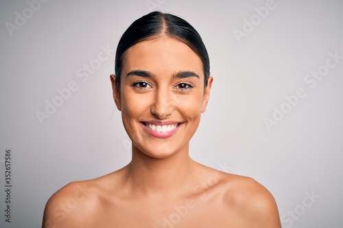 Close up of young beautiful woman with clear and pure skin. Perfect and clean skincare wearing natural makeup. Smiling happy looking fresh and healthy.