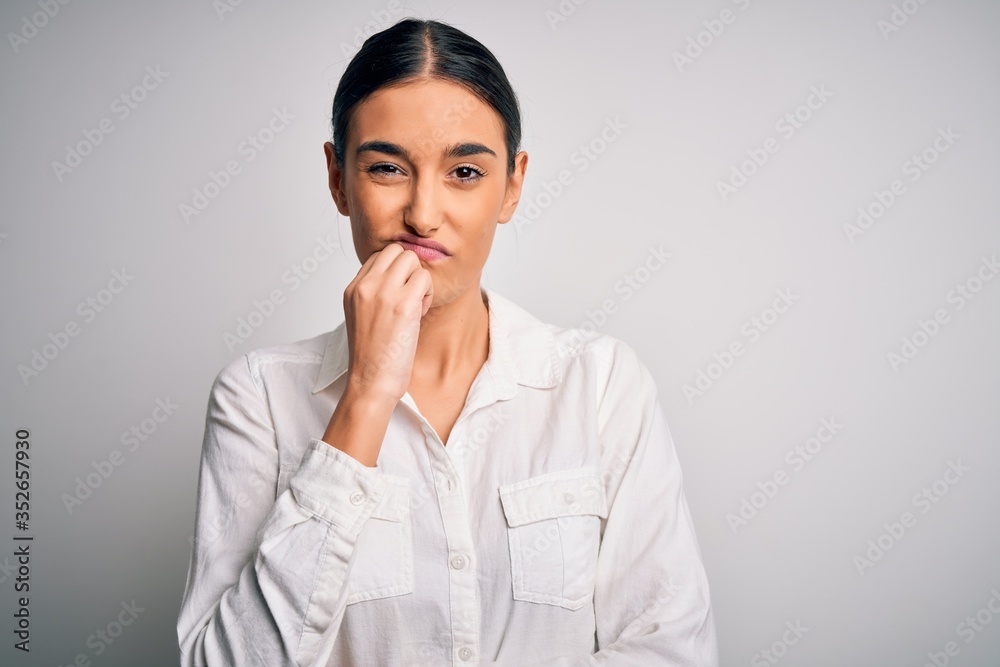 Young beautiful brunette woman wearing casual shirt over isolated white background thinking looking tired and bored with depression problems with crossed arms. Young beautiful brunette woman wearing casual shirt over isolated white background thinking looking tired and bored with depression problems with crossed arms.