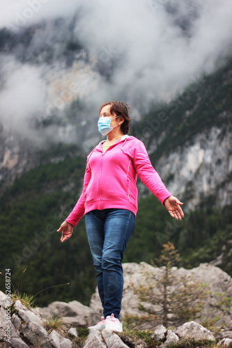 woman in the mountains in protective mask