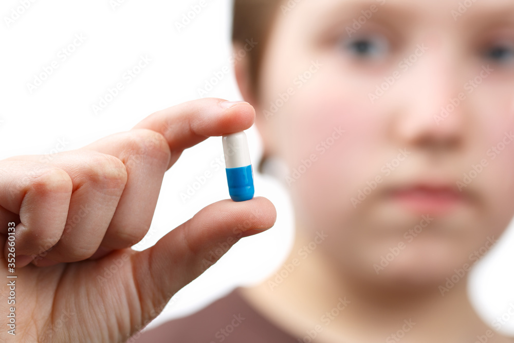 Child holds in the palm a pills. Child holds in the palm a pills.