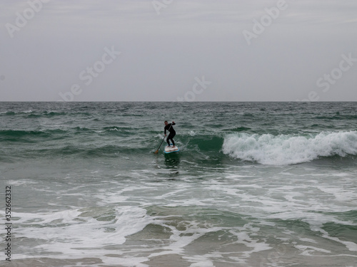 surfer on the high waves on the beach in Bretagne in France