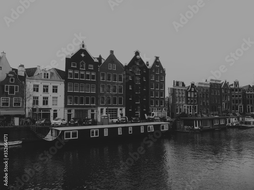 a tristesse view of a canal with old houses of Amsterdam