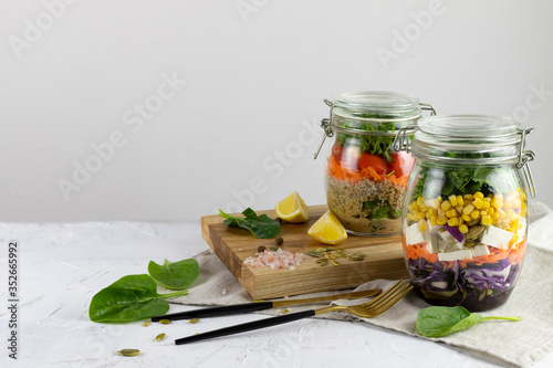 Healthy vegetarian Homemade Mason Jar fresh Salad with Chickpea and Veggies on a light background.Diet, Detox, Clean Eating, Vegan raw food concept.