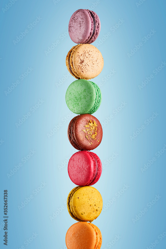 Colorful macaroons stack on light blue background Colorful macaroons stack on light blue background