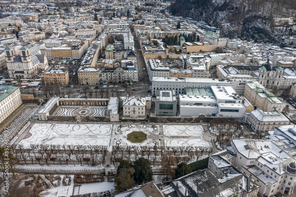 Aerial drone shot view of Mirabell Palace in Salzburg coverd with snow in winter time