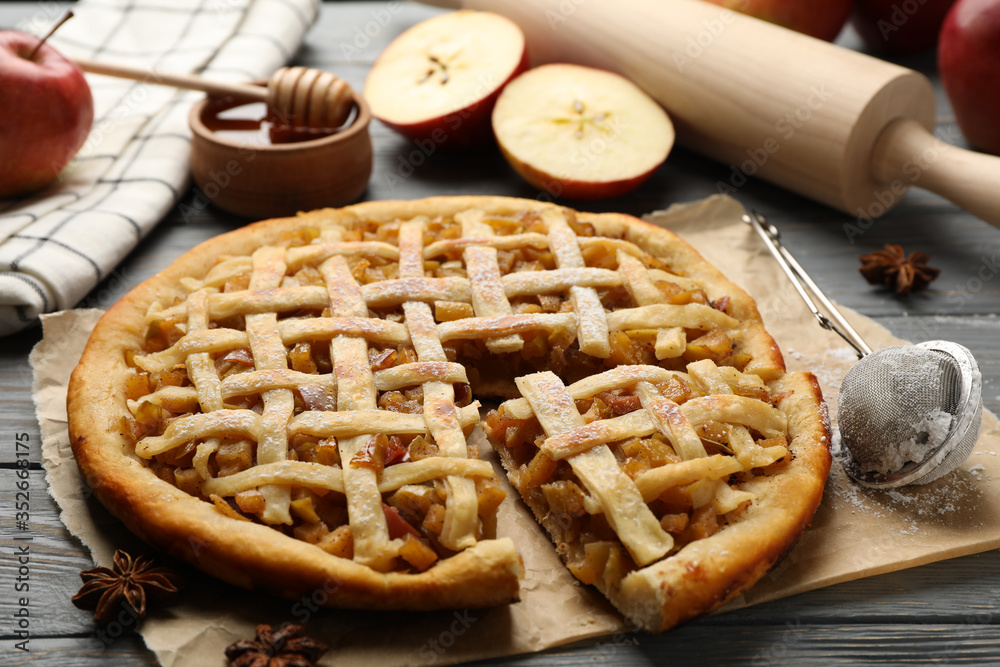 Composition with apple pie and ingredients on wooden background. Homemade food Composition with apple pie and ingredients on wooden background. Homemade food