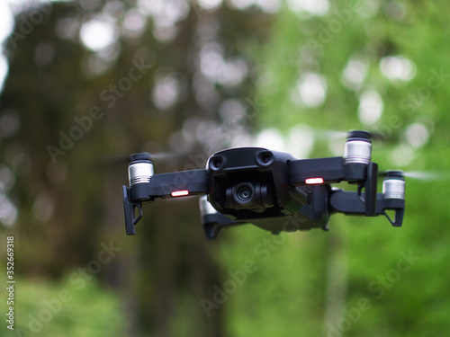 Wallpaper Mural Unmanned drone flies against the background of the nature of the forest, a drone with a digital camera Torontodigital.ca