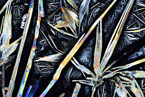 Colorful micro crystals in polarized light. Photo through a microscope. photo