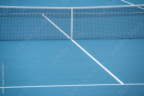 A phopto of an outdoor blue tennis court