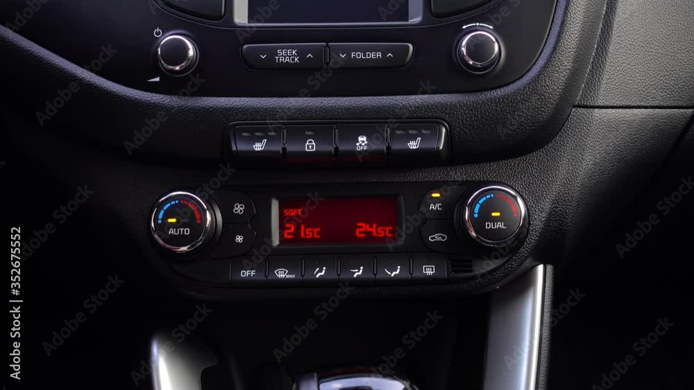 Man adjusts the temperature in the car. Man adjusts the temperature in the car.