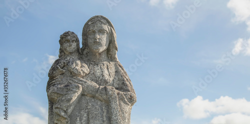 Ancient stone statue of Virgin Mary with baby Jesus Christ