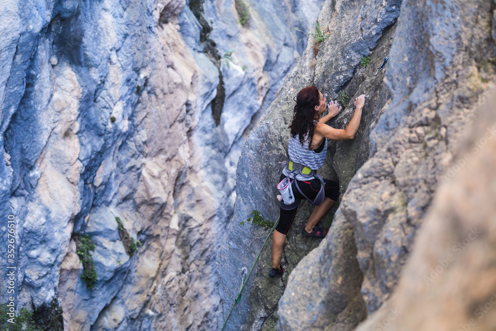 A woman is climbing in Turkey, Turkish woman climbs the rock.