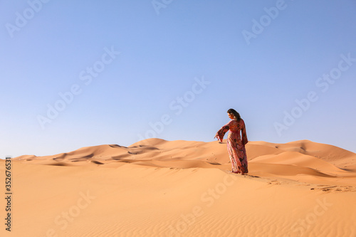 A girl in a beautiful Moroccan dress. Merzouga Morocco.