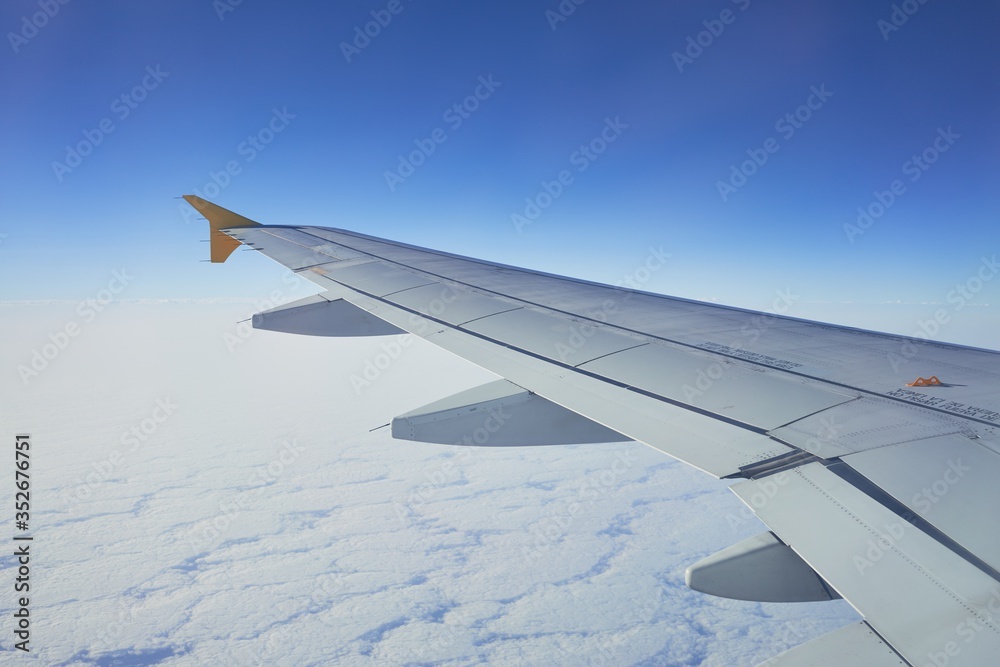 Obraz premium Cloudscape from window airplane, landscape of wing plane on a cloudy sky