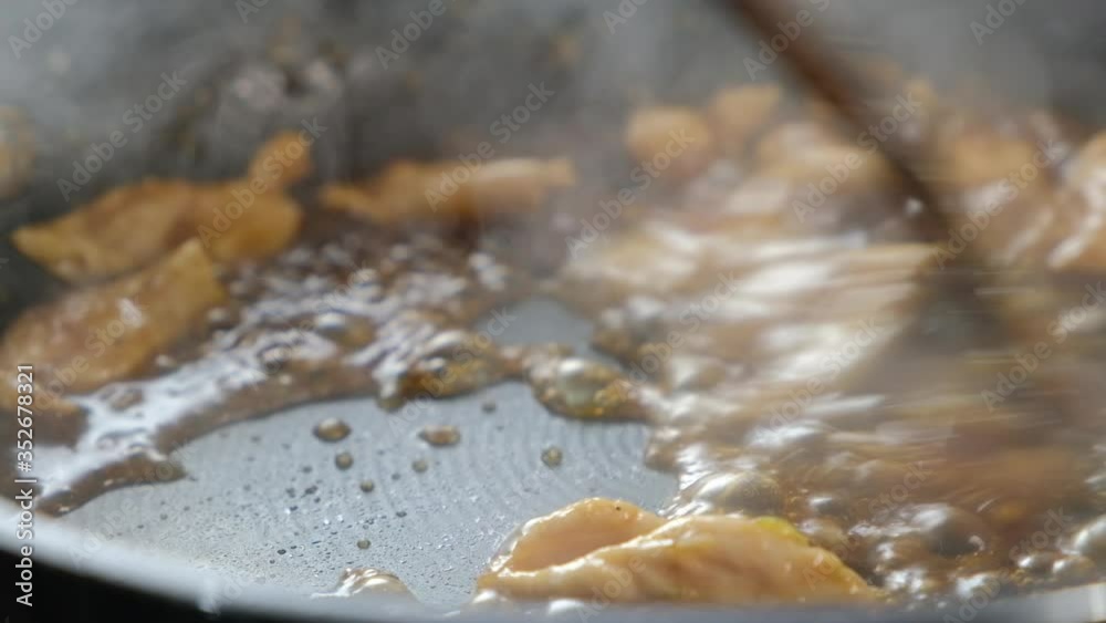 frying chicken meet in pan with dark soy sauce with steam rising from pan. Close up Cooking chicken in Sauce. frying chicken meet in pan with dark soy sauce with steam rising from pan. Close up Cooking chicken in Sauce.