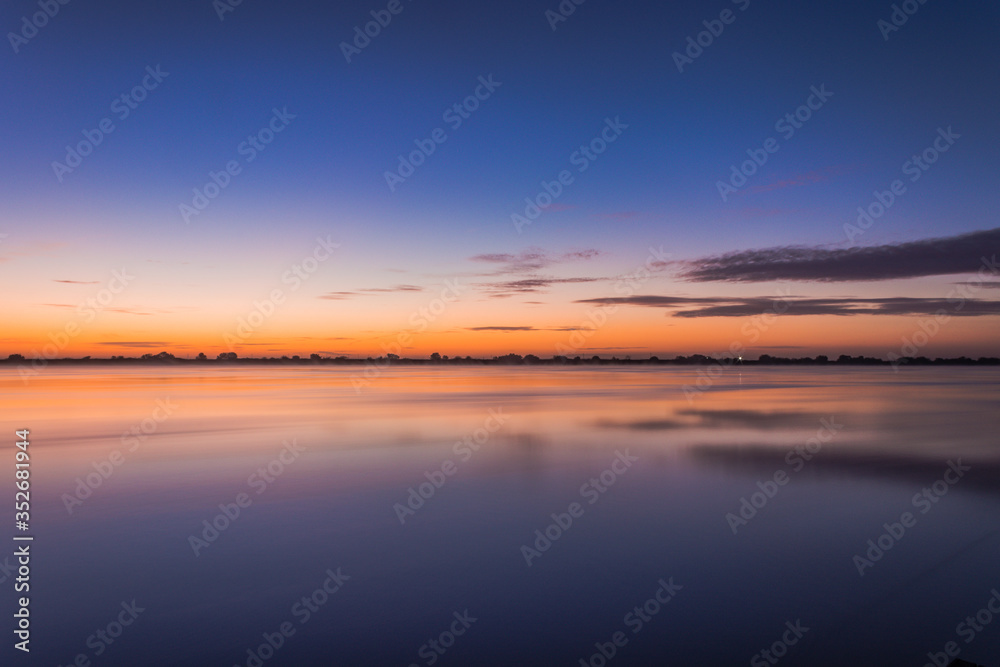 River at sunrise with a cloudy sky