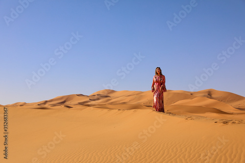 A girl in a beautiful Moroccan dress. Merzouga Morocco.