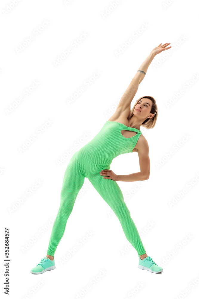 full body portrait of young sporty woman stretching before exercise isolated on white background. full body portrait of young sporty woman stretching before exercise isolated on white background.