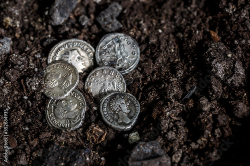 Ancient coin of the Roman Empire.Authentic silver denarius, antoninianus of ancient Rome.Roman silver coins covered in dirt.Antikvariat. photo