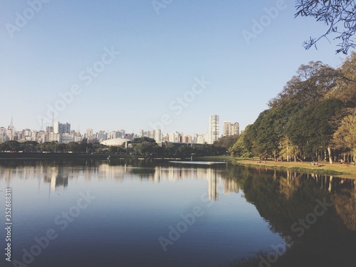 Scenic View Of Calm River By City Against Clear Sky © henrique junqueira/EyeEm