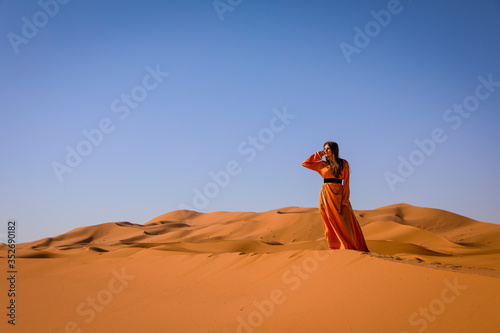 A girl in a beautiful Moroccan dress. Merzouga Morocco.