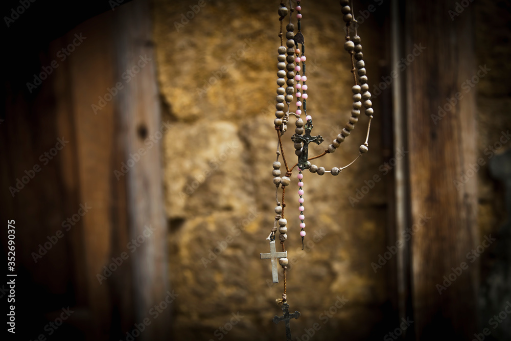 Old rosary against ancient ruins of church as a symbol of salvation and eternal life of human soul Old rosary against ancient ruins of church as a symbol of salvation and eternal life of human soul
