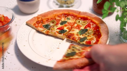 Familia unida pegando pedaços de pizza na mesa - Close fechado na mão pegando pedaços de pizza photo