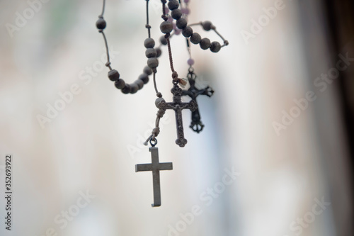 Old rosary against ancient light background as a symbol of salvation and eternal life of human soul