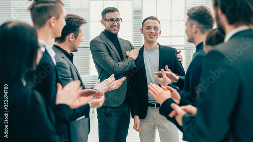 boss and business team congratulating their colleague