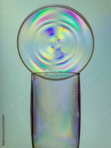 Empty shampagne glass with plastic colorful circle, polaraized photo style photo