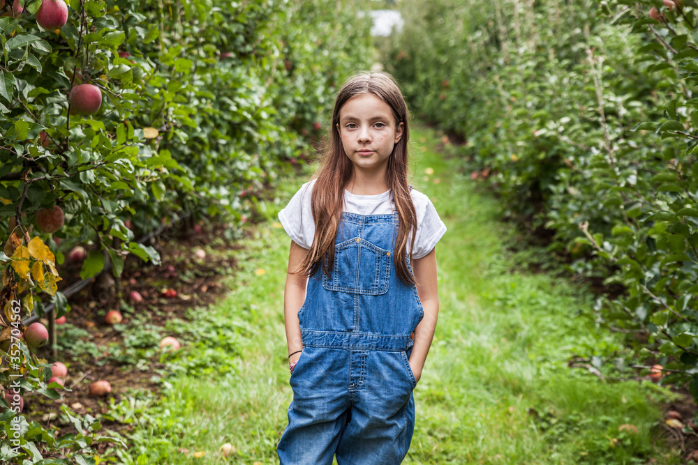 Cute little girls portrait in apple orchard. Cute little girls portrait in apple orchard.