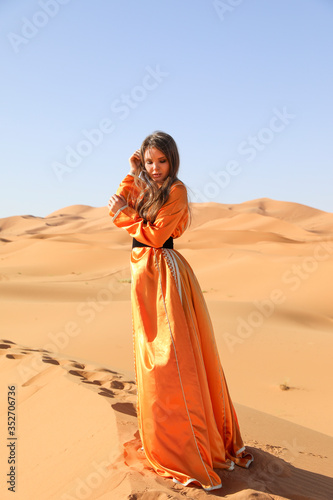 A girl in a beautiful Moroccan dress. Merzouga Morocco.