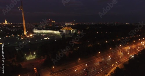 4K night aerial video of Kutuzovskiy Avenue highway at Victory Park and memorial complex in Poklonnaya Hill, near Moscow River in Moscow, Russia