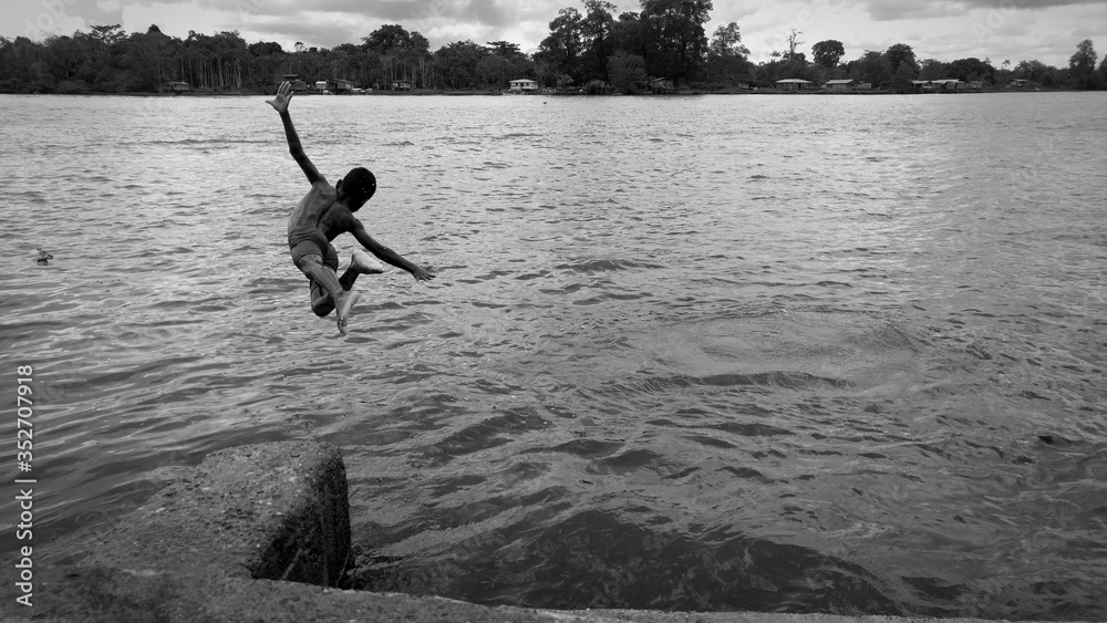 Shirtless Boy Diving Into Lake Stock Photo | Adobe Stock