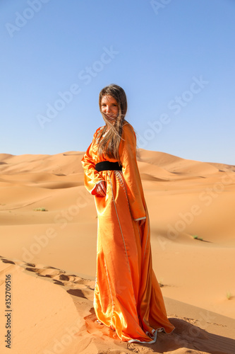 A girl in a beautiful Moroccan dress. Merzouga Morocco.