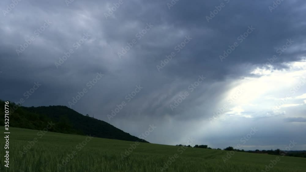 Shot by a hill with movement of the clouds over a agriculture field - TIME LAPSE Shot by a hill with movement of the clouds over a agriculture field - TIME LAPSE