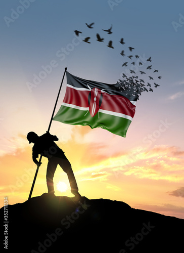 Φωτογραφία Kenya flag turn to birds while being planted by a man on a hill during sunrise