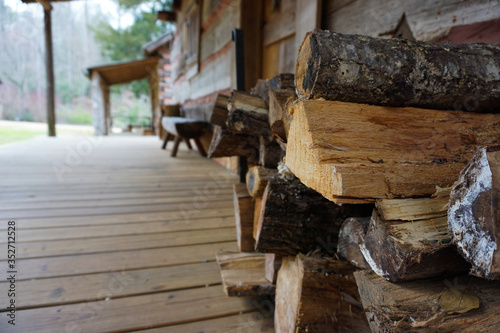 Logs Stacked Agains a Cabin