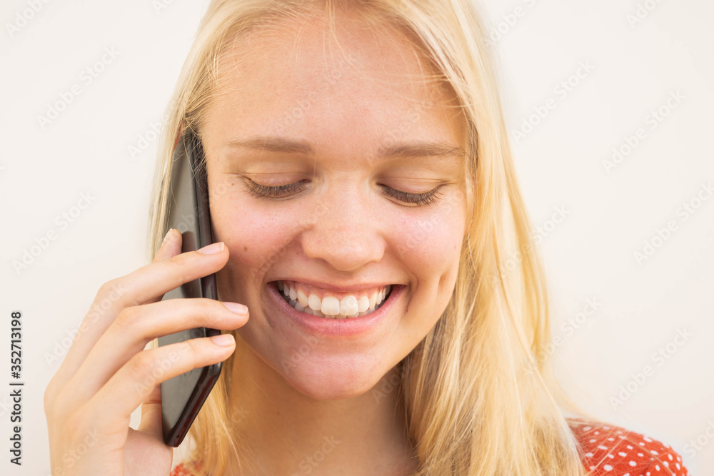 Happy pretty young woman talking on the phone. Electronic communication. Happy pretty young woman talking on the phone. Electronic communication.