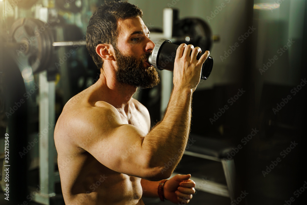 Side view portrait of young muscular caucasian man bodybuilder
