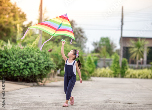 Close-up view of cute girl playing with sports (kite sport), learning outside the classroom during the summer semester and making good use of leisure time.