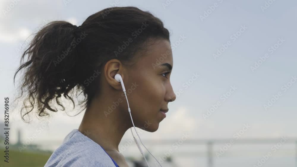 Afro-american Fitness woman warms up and stretching outdoors before run Afro-american Fitness woman warms up and stretching outdoors before run