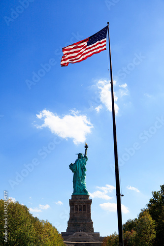 Back view of  statue of liberty and flag of the United States © vacant