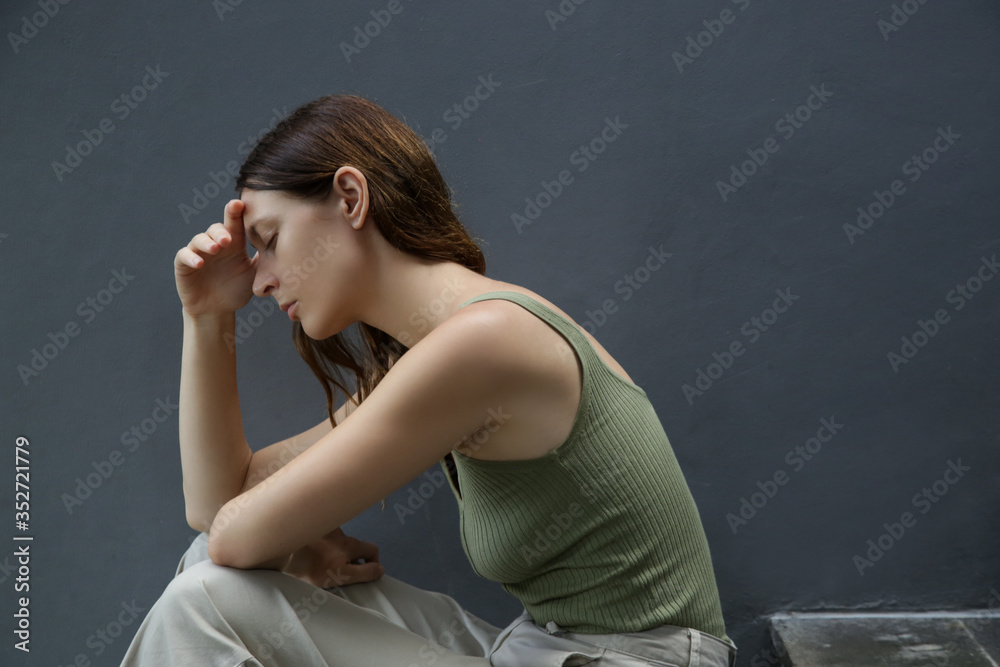 Portrait of depressed woman, covering face with her hands Portrait of depressed woman, covering face with her hands
