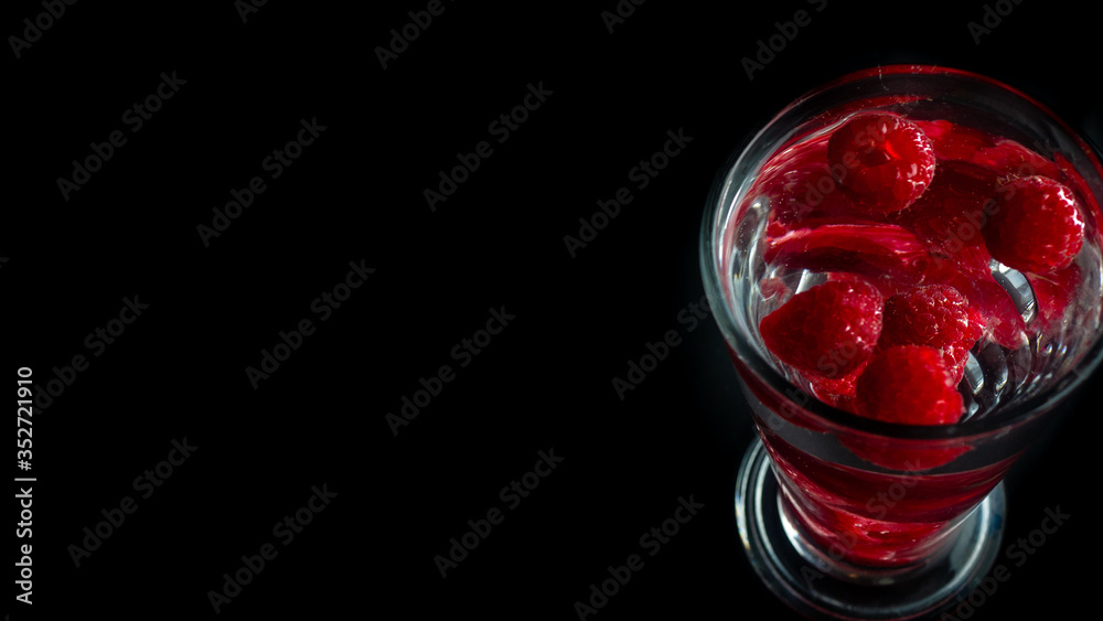 Raspberries in a water glass. Free entry space.
Raspberries in a water glass. Free entry space.