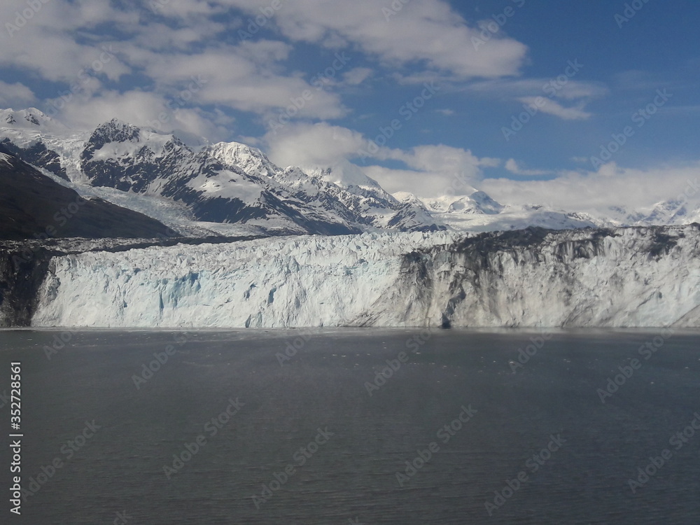 Alaska glacier, lake, mountains, snow and blue sky on a sunny day