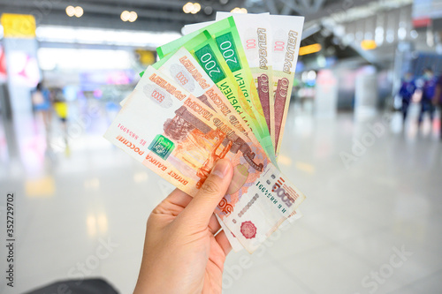 Close-up of someone holding and showing variety of Russian banknotes in the hand. The Russian ruble is the currency of the Russian Federation.