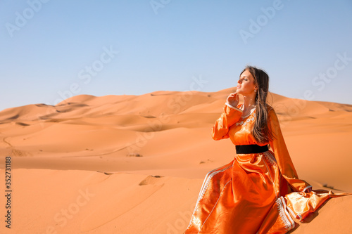 A girl in a beautiful Moroccan dress. Merzouga Morocco. photo