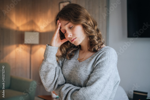 Worried young woman with hands on head